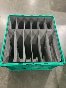 Large green boxes with gray compartments inside