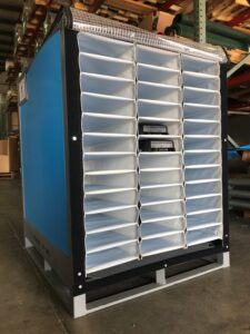 A blue storage cabinet in a warehouse kept on the floor of the company.