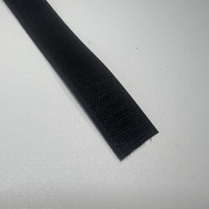 A black strip of fabric on top of a table.