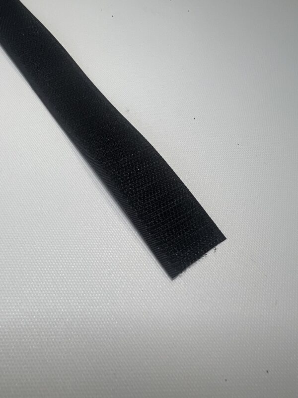 A black strip of fabric on top of a table.