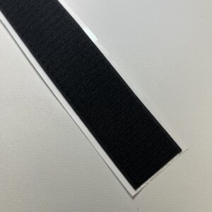 A black strip of tape on top of a table.