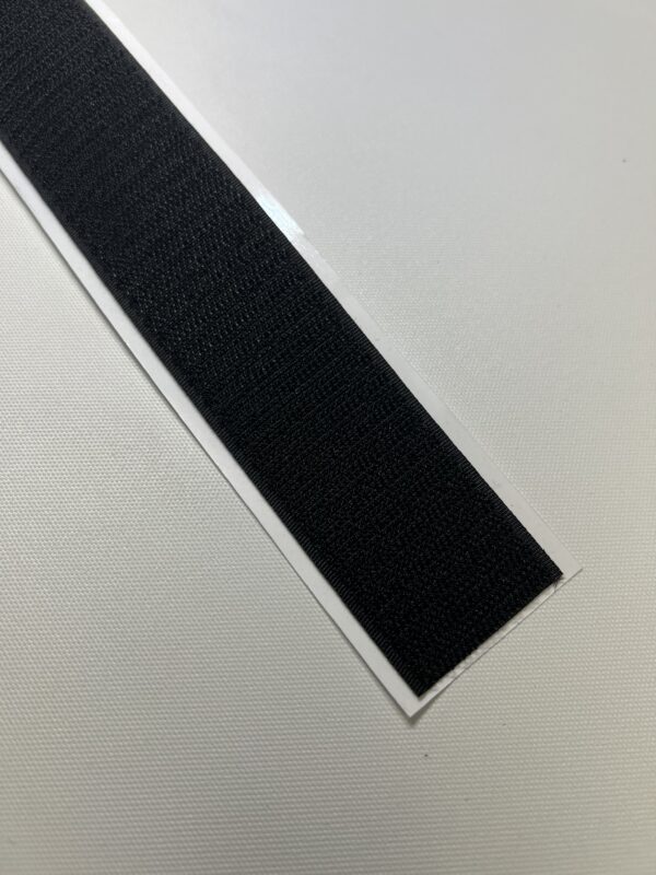 A black strip of tape on top of a table.