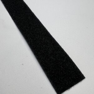 A black strip of fabric on top of a white surface.