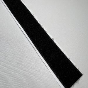 A black strip of tape on top of a white surface.